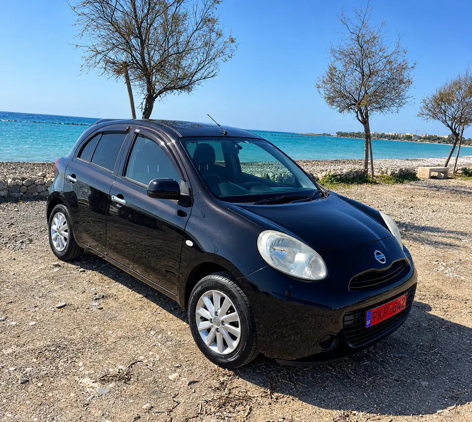 A black Nissan Micra from the Nippy Turtle fleet on the beach road